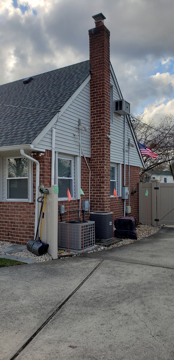 Professional chimney repointing restoring brick joints in Massapequa Park, NY